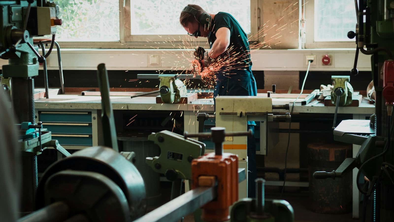 selective focus photography of man using angle grinder